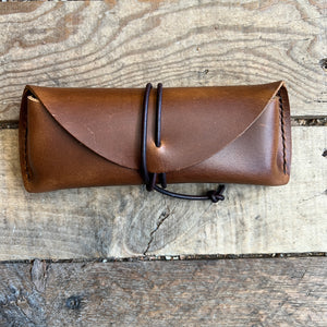 Hand stitched leather eyeglass case.